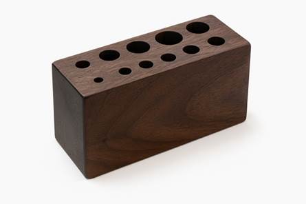 A wooden block with holes

AI-generated content may be incorrect.