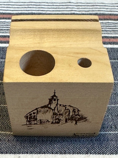 A wooden box with holes

AI-generated content may be incorrect.